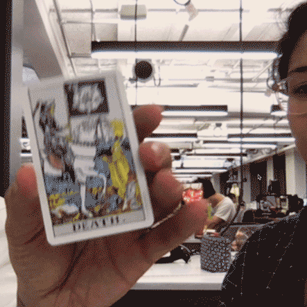 An animated Death tarot card being held to the camera in AR.